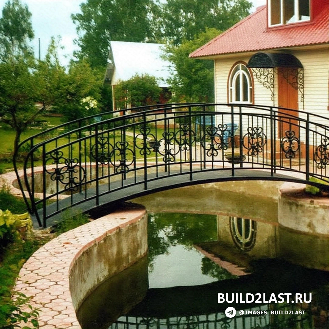 Мост из светлого дерева через искусственный водоем в саду